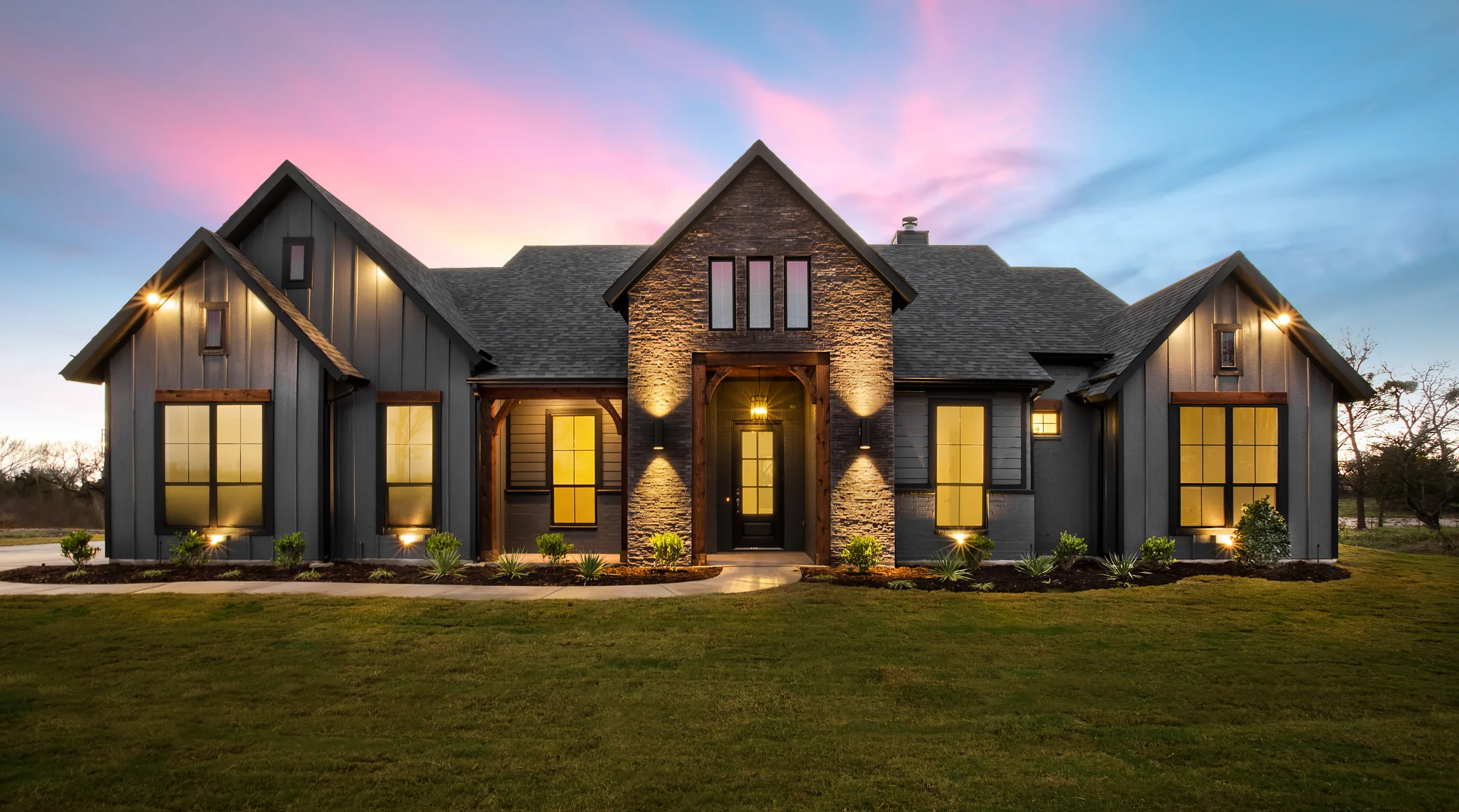 Renovated home exterior with updated lighting, envelope, and landscaping.
