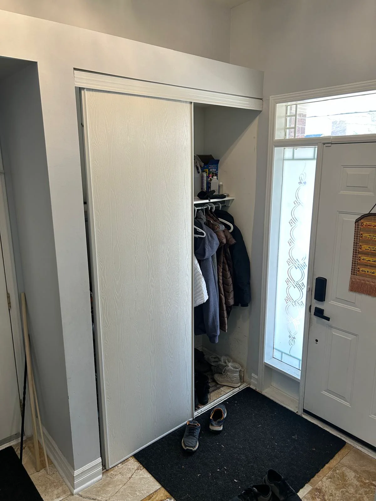 Original entry closet before the custom cabinet installation.